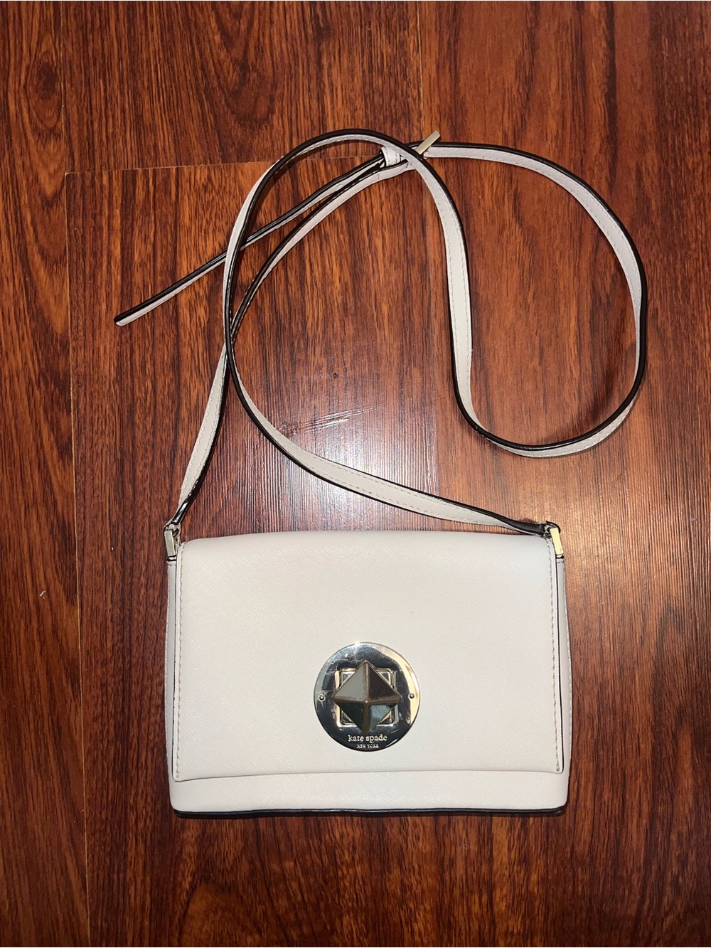 kate spade cream crossbody with gold logo disc
